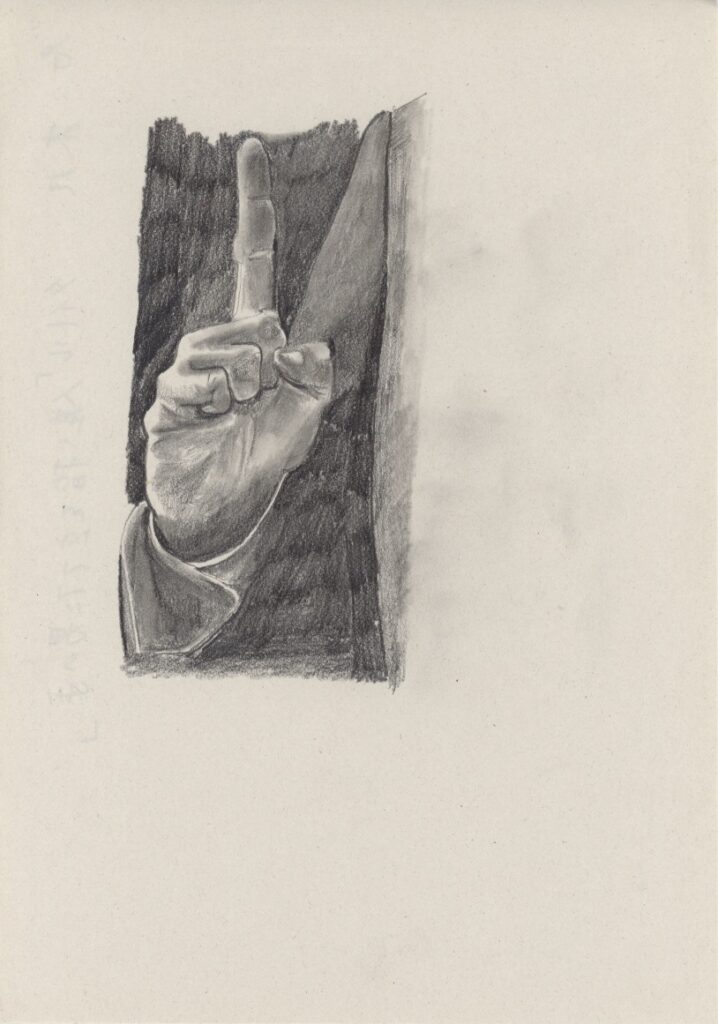 人差し指を立てた男の手